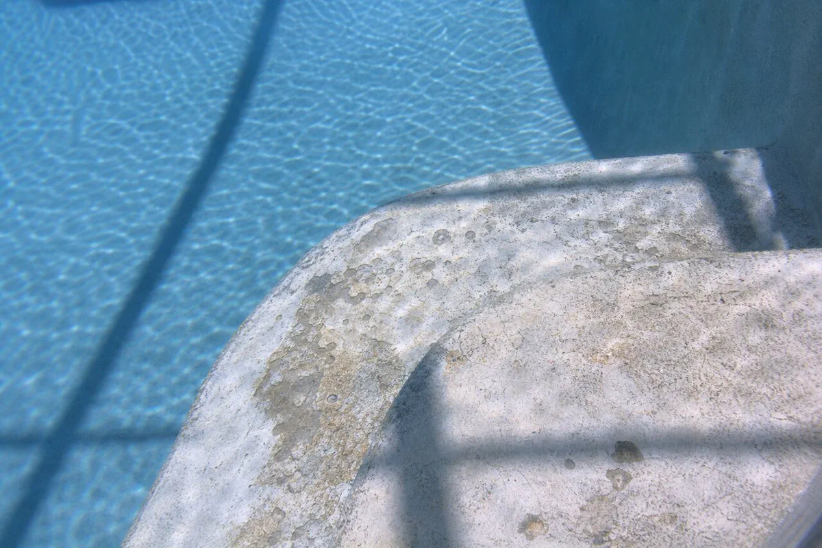 Illustrative chipped pool step and rough plaster surface for Palm Bay resurfacing review